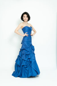 女性がポーズをとり立っている